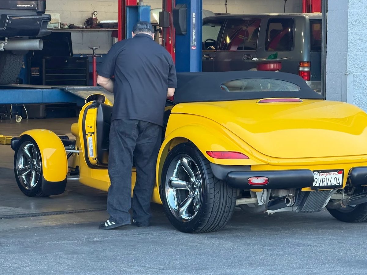 Yellow Plymouth Prowler receiving expert service