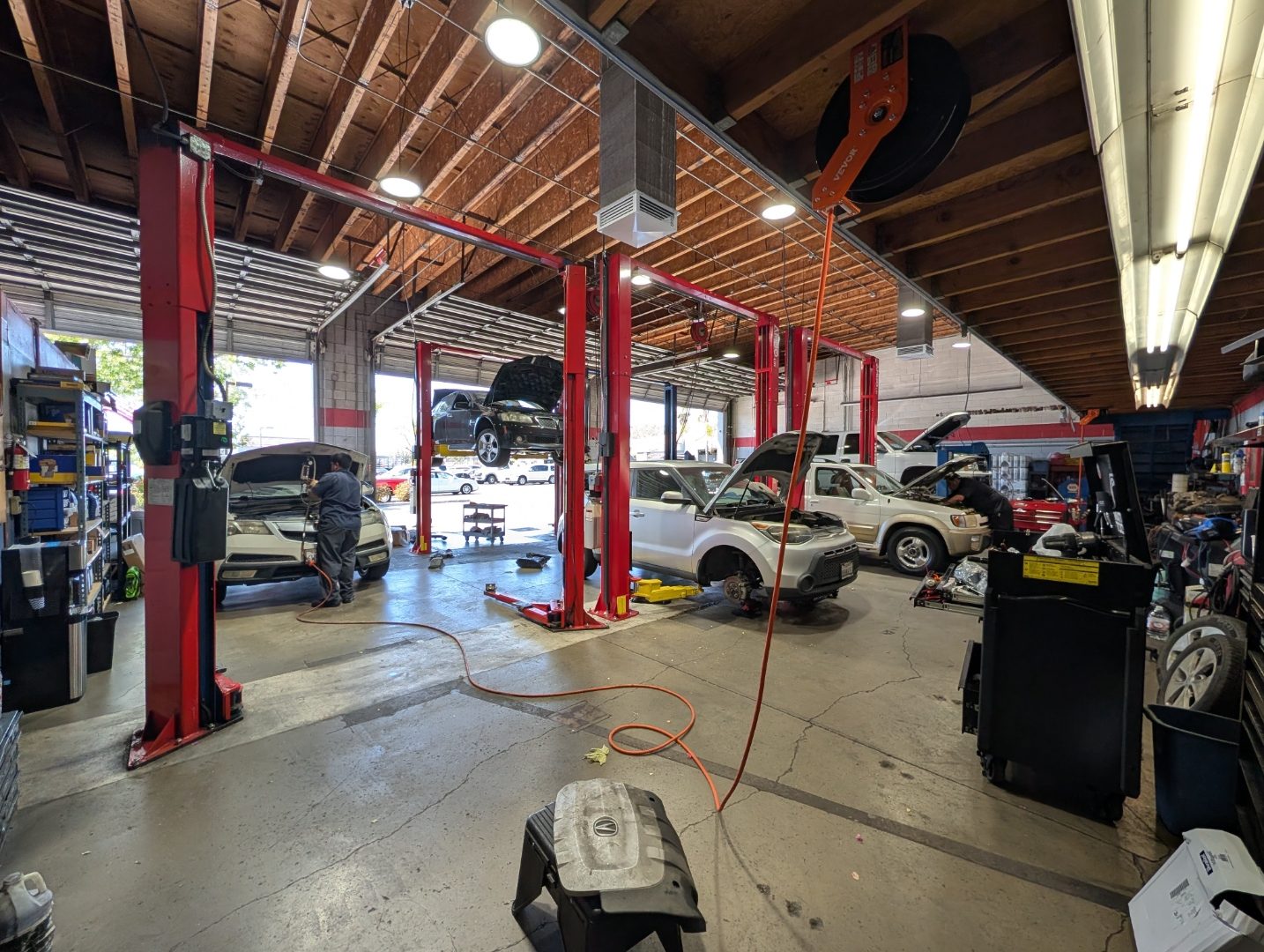 Perry's Quality Auto wide shop interior with classic cars and professional tool walls