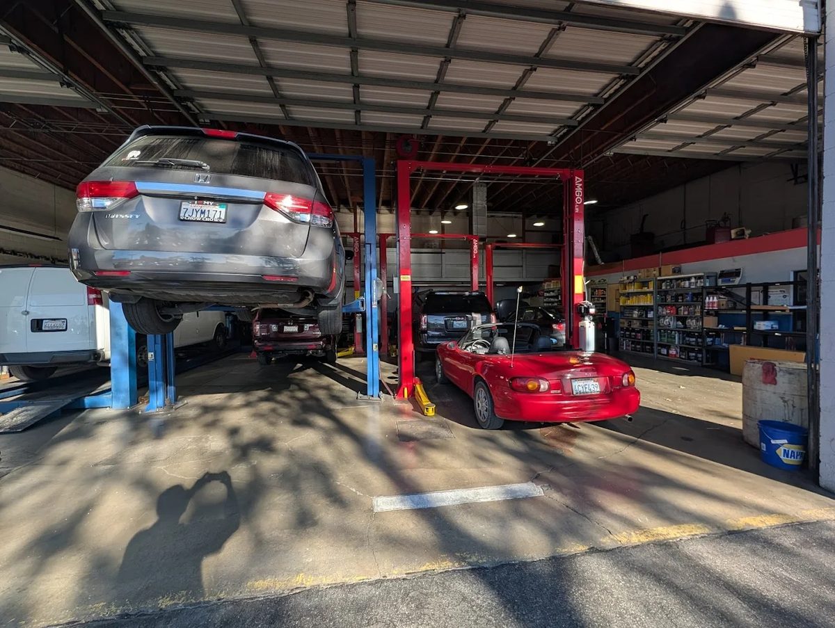 Car on lift inside Perry's auto repair shop