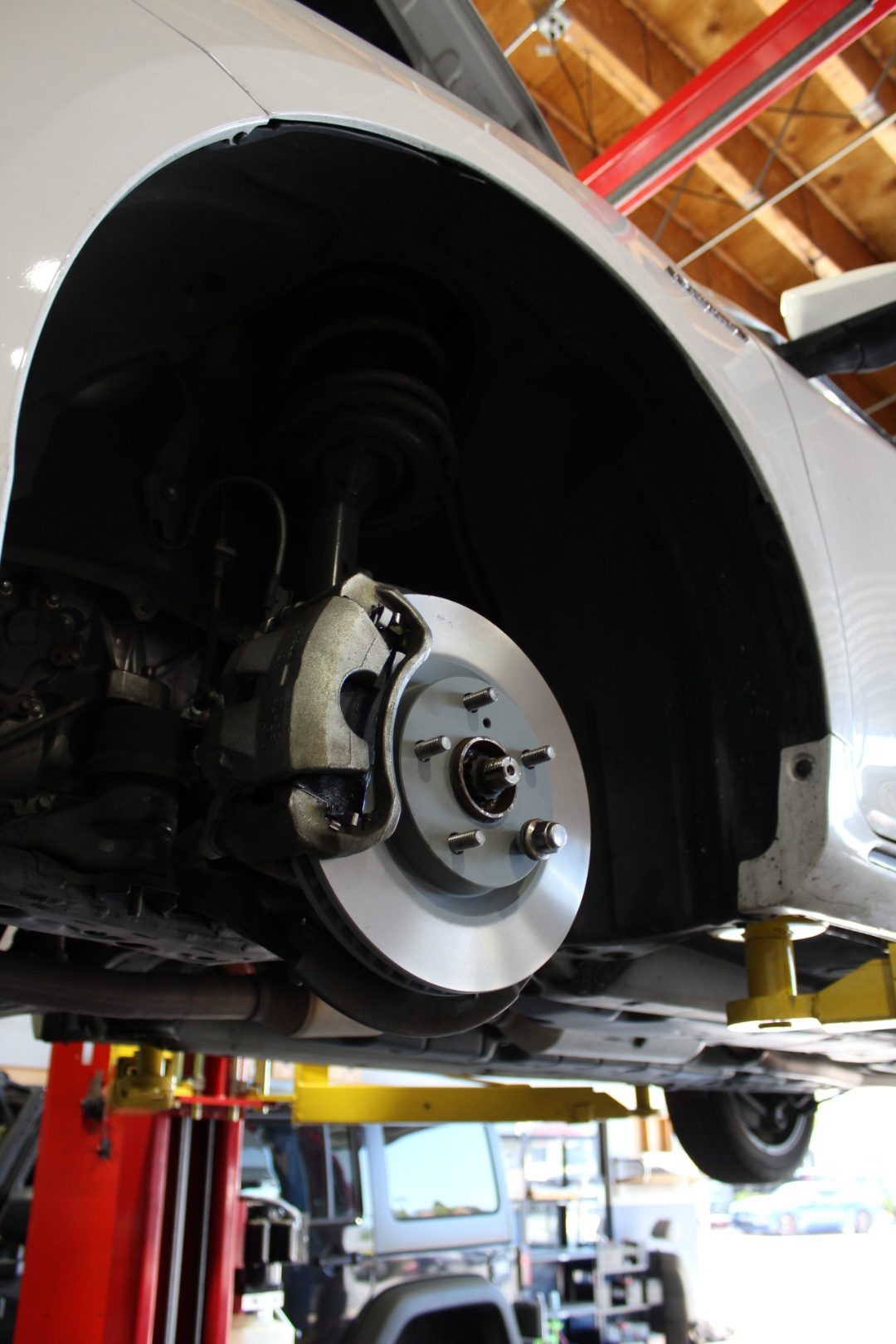 Fresh brake rotor and caliper exposed during a brake service at Perry's Quality Auto in Simi Valley
