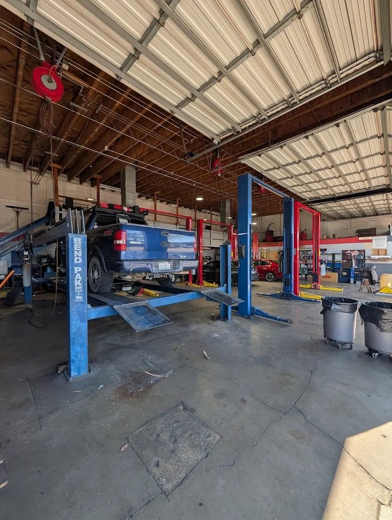 Blue truck on BendPak lift for undercarriage service
